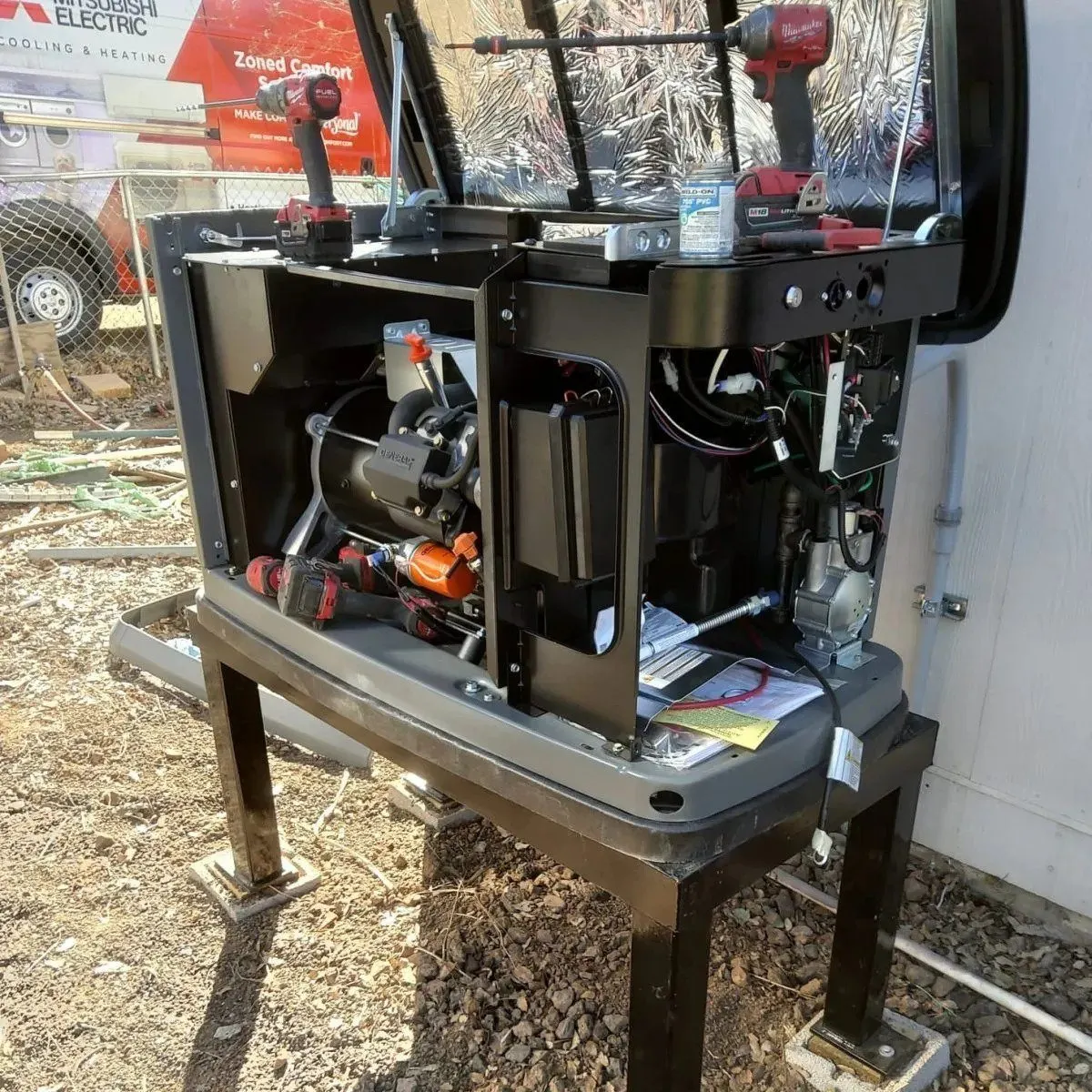 Generator with panels removed being repaired by Jonas Energy technicians.